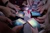 People using smartphones, representing how AI technology powers modern mobile features.